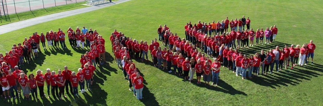 people standing to form the word ONE