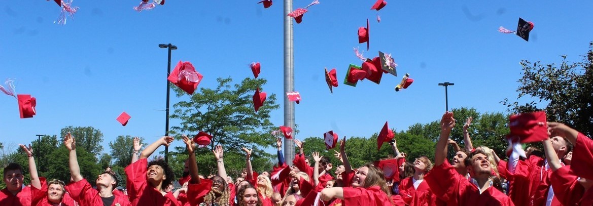 seniors tossing caps in the air at graduation