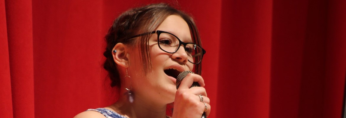 girl singing into microphone