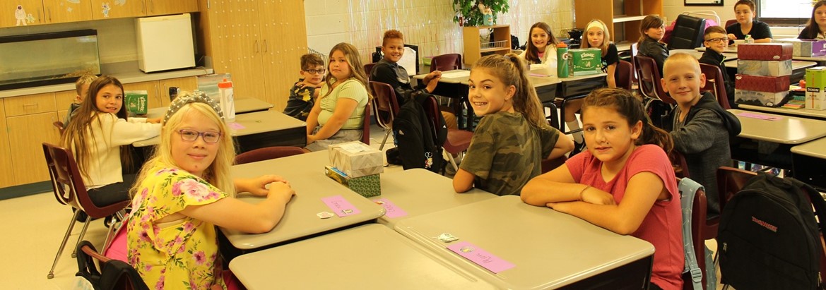 students sitting in classroom at desks