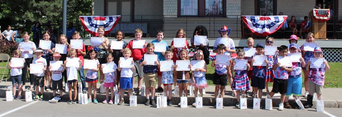 students standing holding certificates