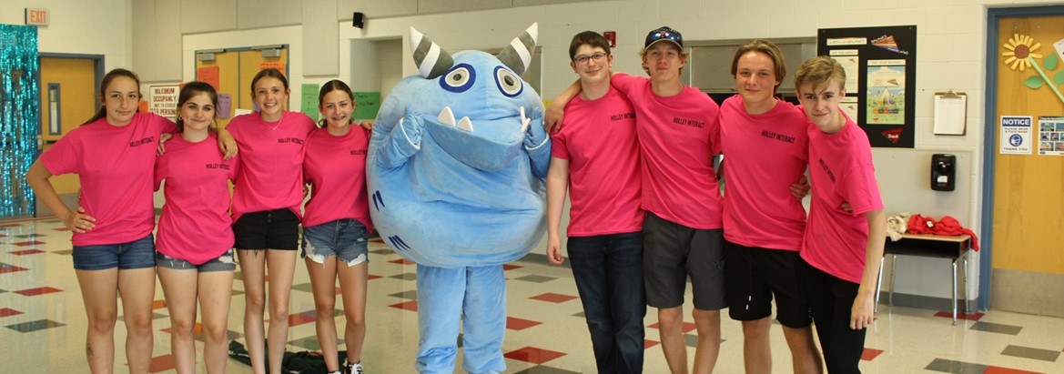 students standing with costumed character