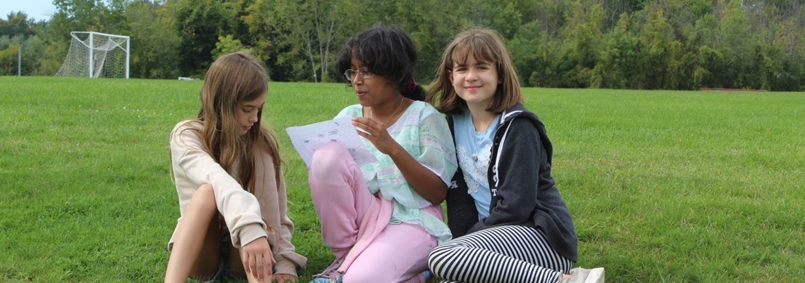 students reading in grass