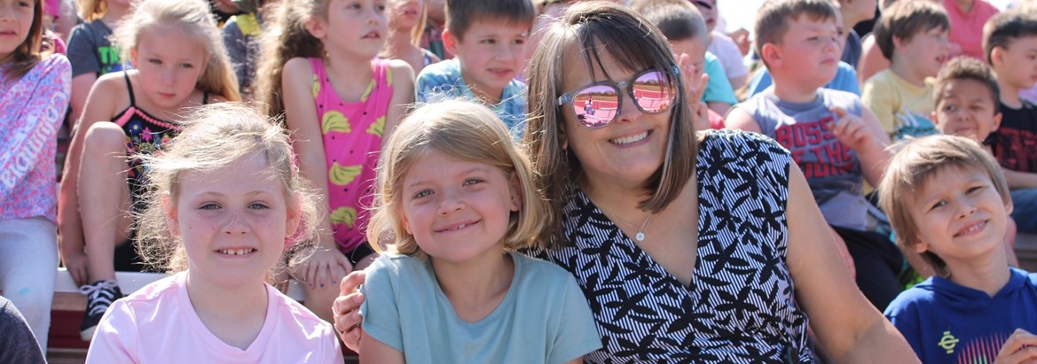 students smiling with teacher
