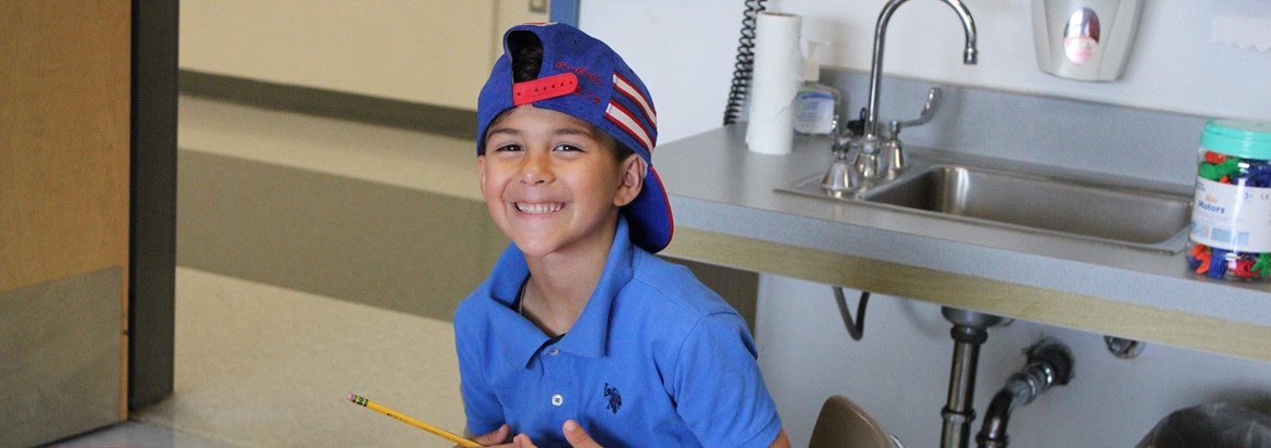student smiling doing work