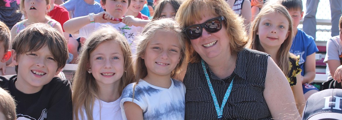 students smiling with their teacher