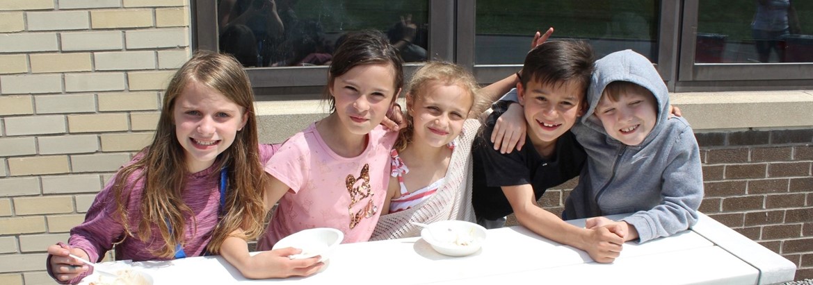 group of students smiling eating ice cream