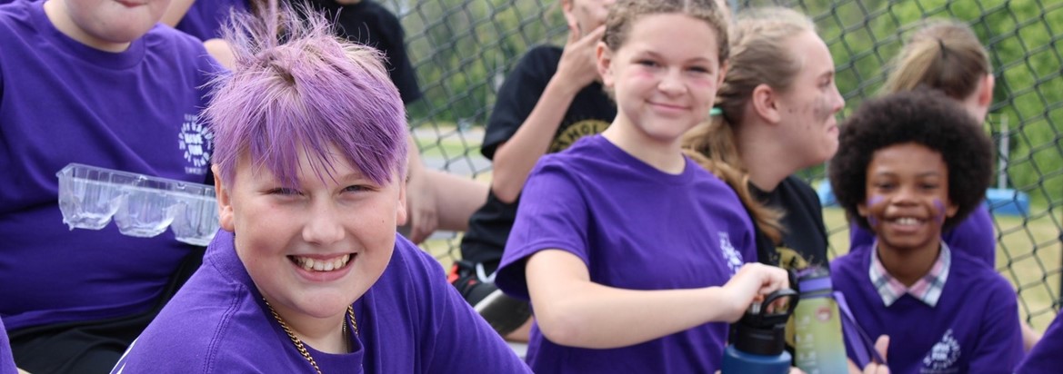 students smiling in purple